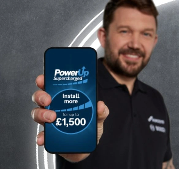 Installer with mobile phone showing supercharged promotion